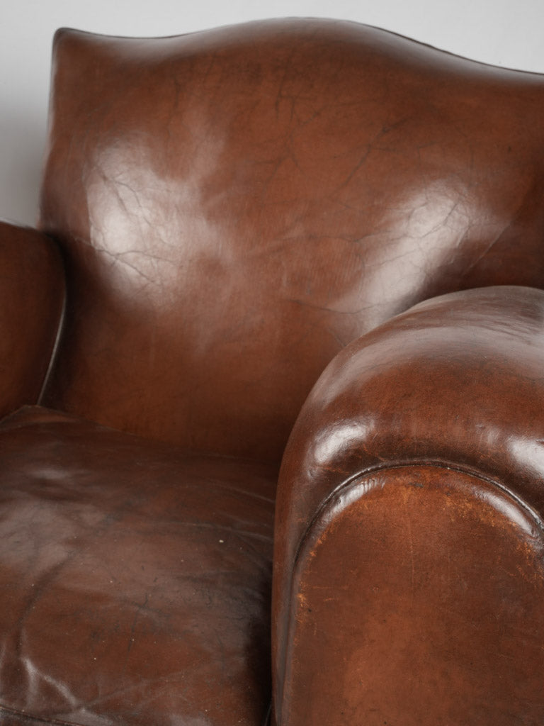 Aged leather detailed club chairs