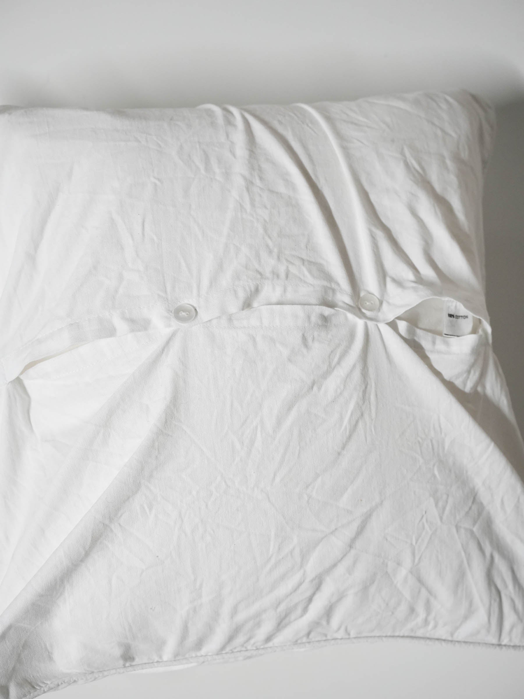 White pillowcase embroidered with colorful butterflies