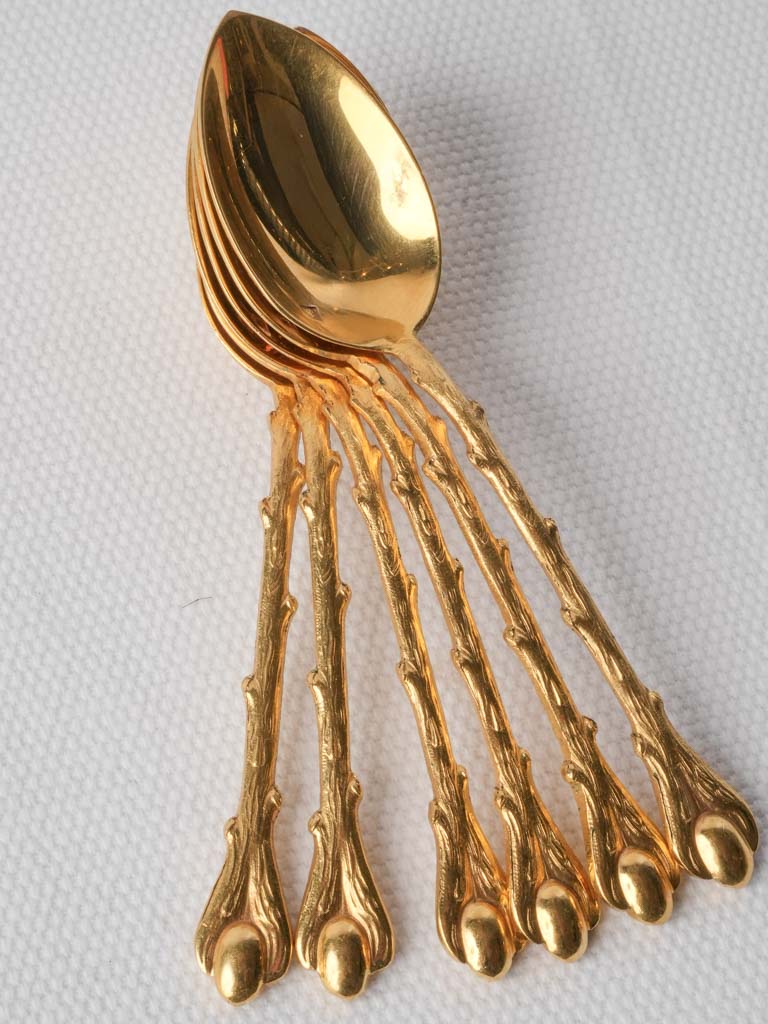 Warm reflective gilded spoons set  