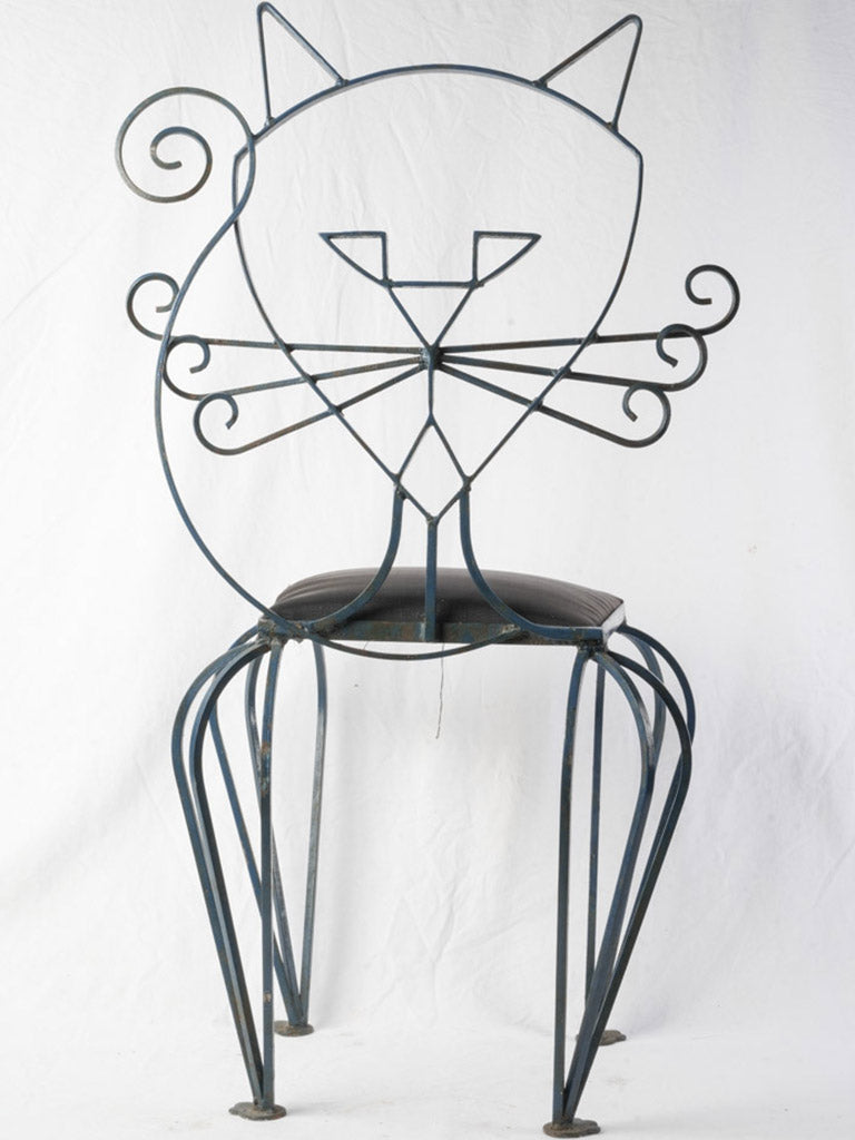 Sculptural occasional cat-back chairs.