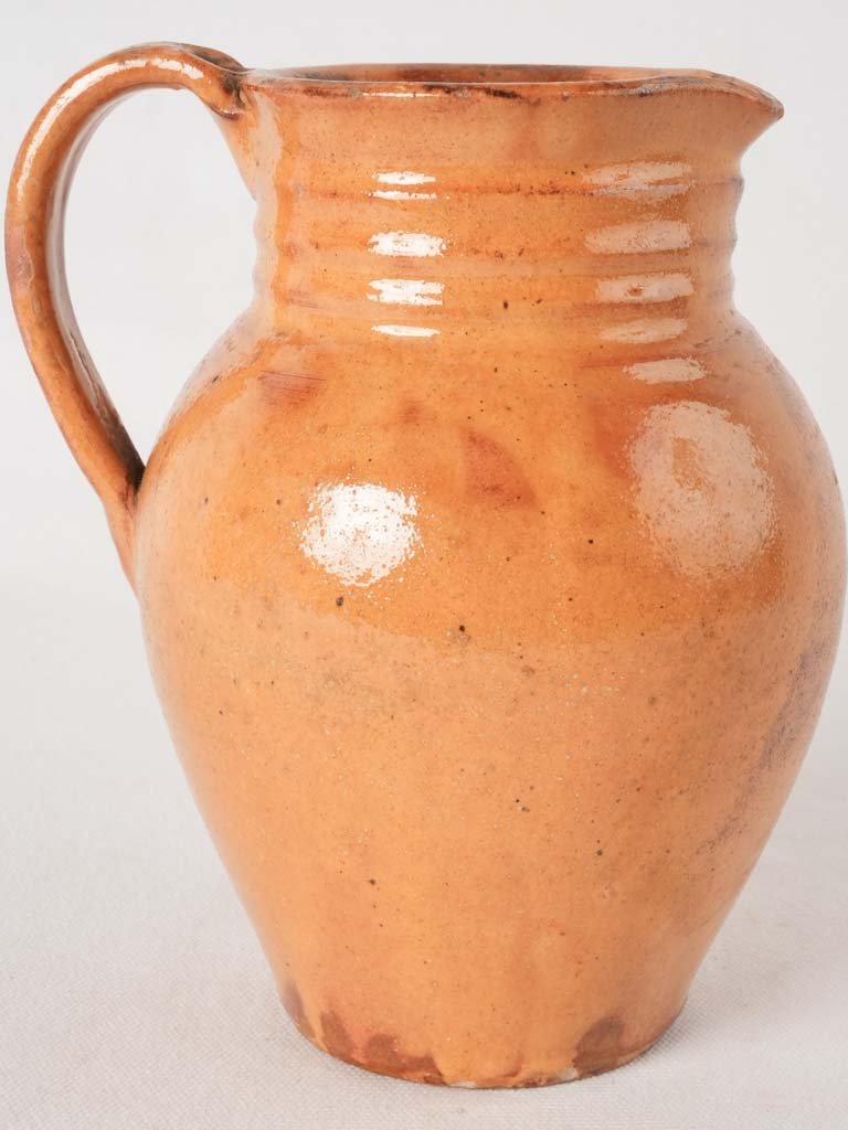 Ocher pitcher w/ ribbing at top 8"