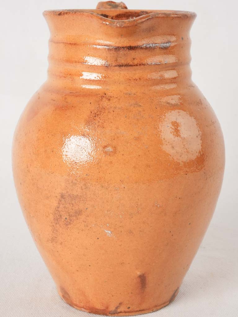 Ocher pitcher w/ ribbing at top 8"