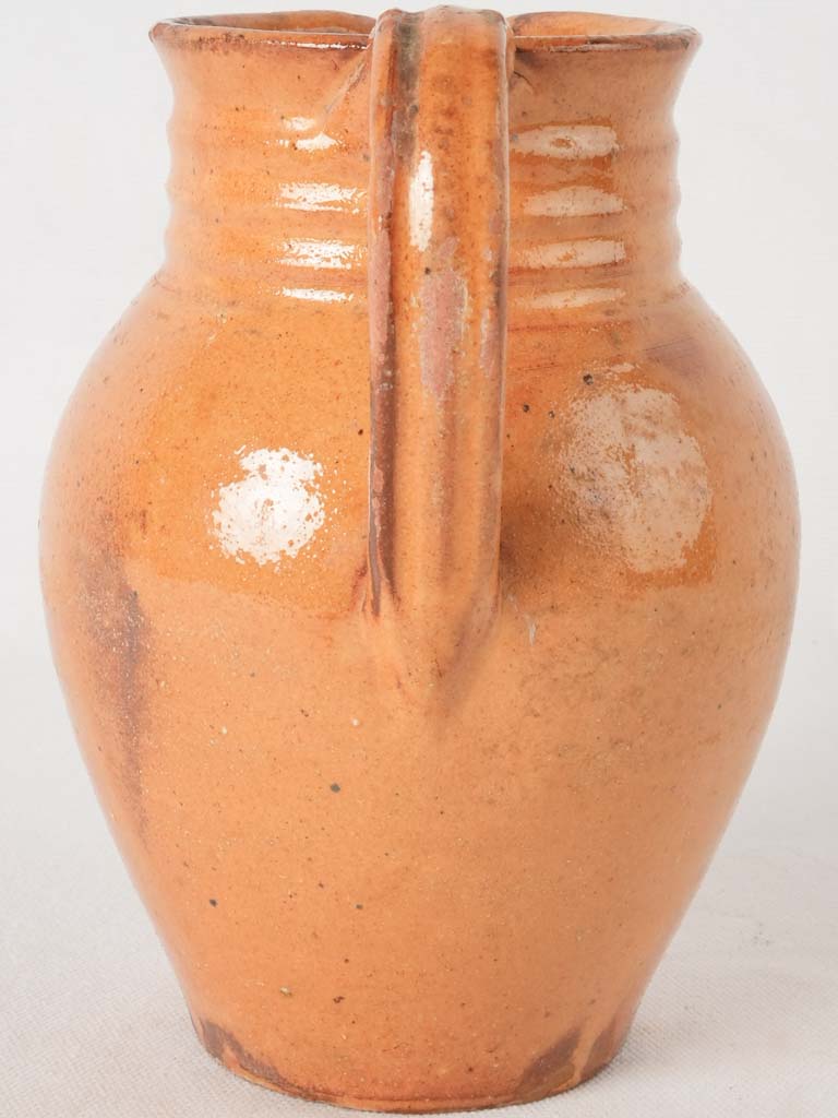 Ocher pitcher w/ ribbing at top 8"