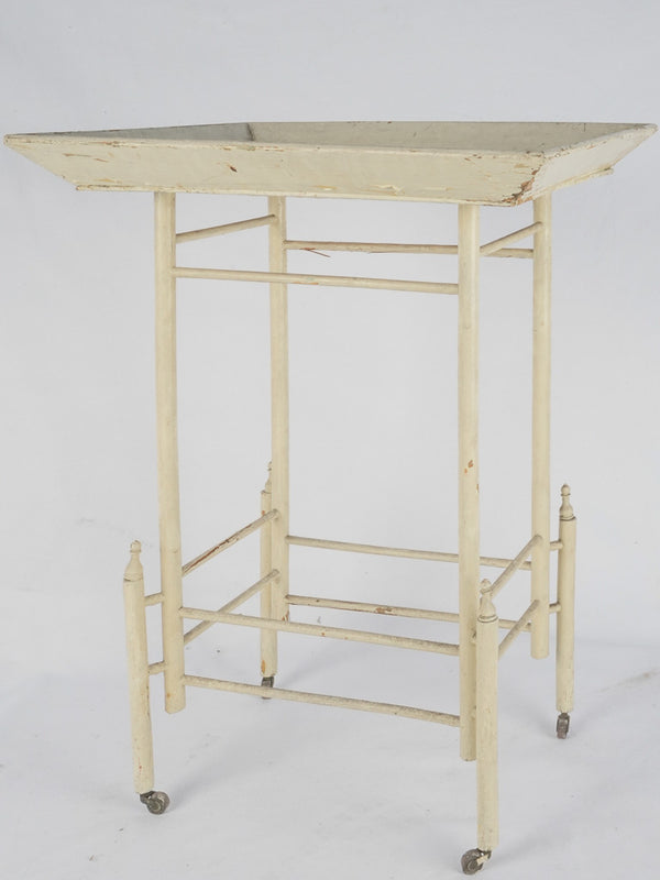 Antique cream-finished wooden bar cart