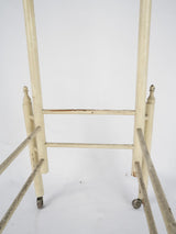 Historical cream-painted wooden bar cart