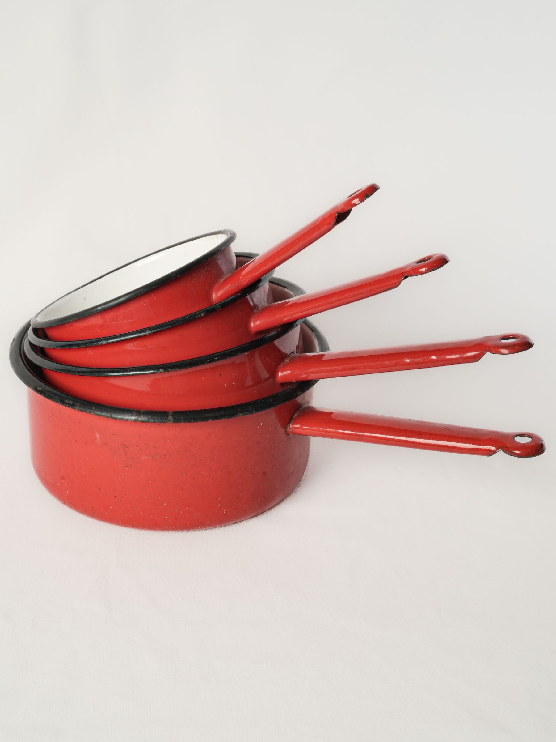 Set of Four Graduated Red Enamel Saucepans