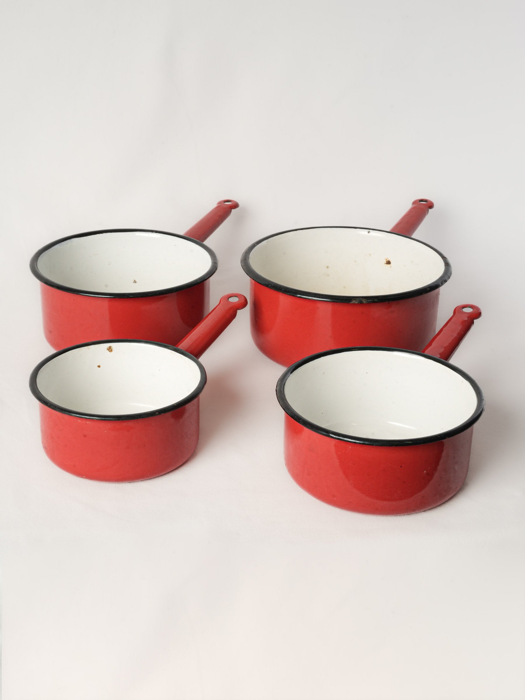 Set of Four Graduated Red Enamel Saucepans
