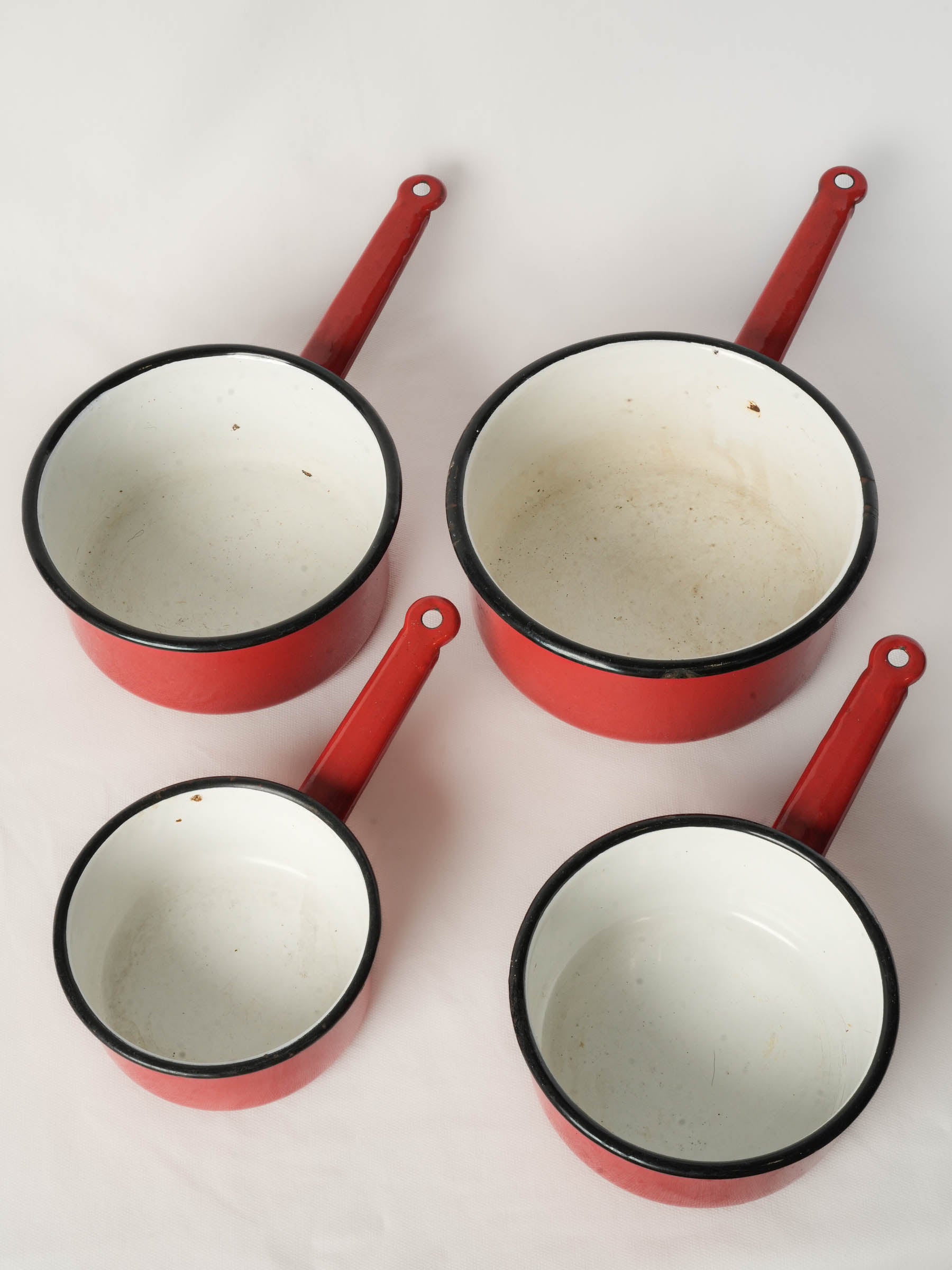 Set of Four Graduated Red Enamel Saucepans