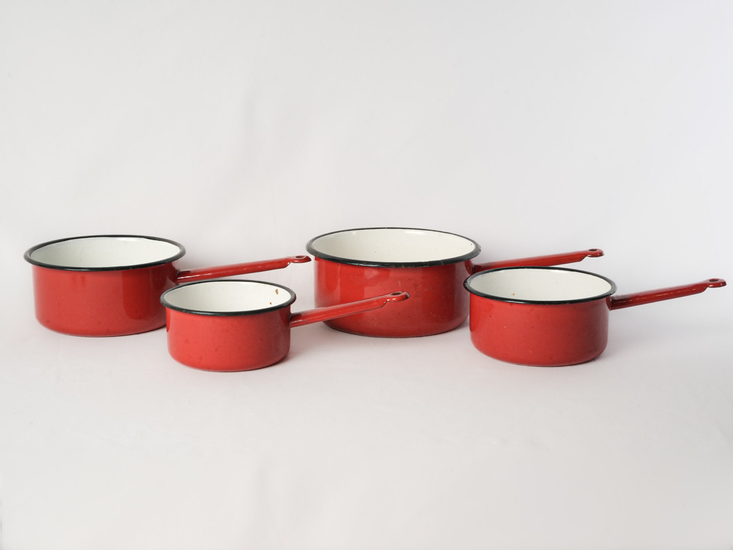 Set of Four Graduated Red Enamel Saucepans