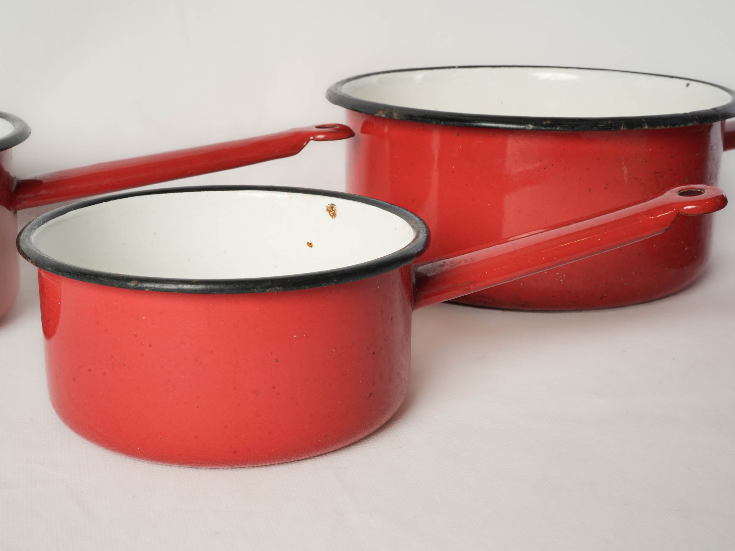 Set of Four Graduated Red Enamel Saucepans