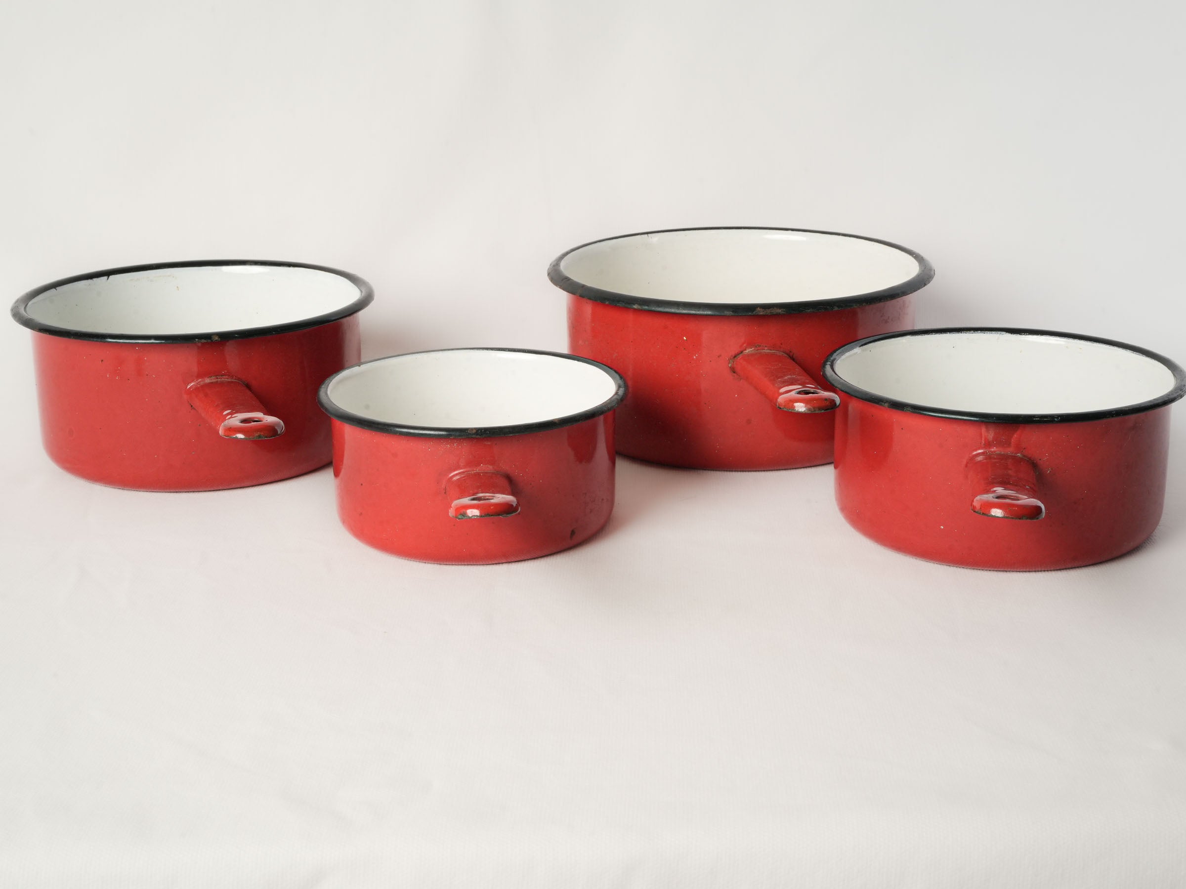 Set of Four Graduated Red Enamel Saucepans
