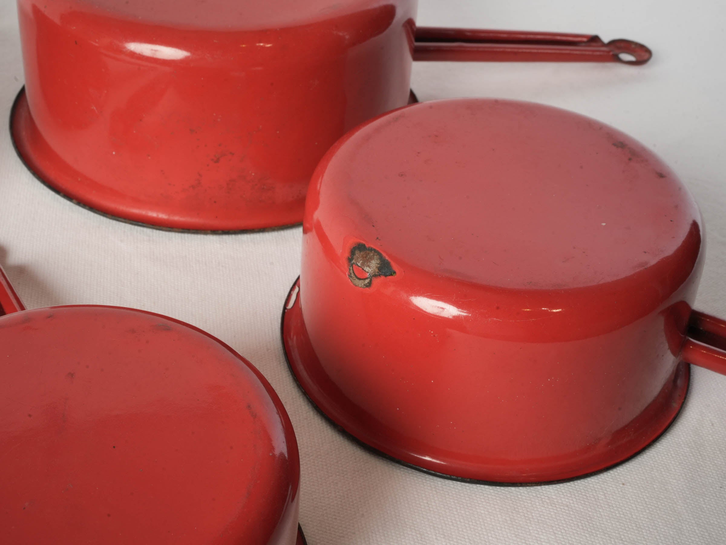 Set of Four Graduated Red Enamel Saucepans