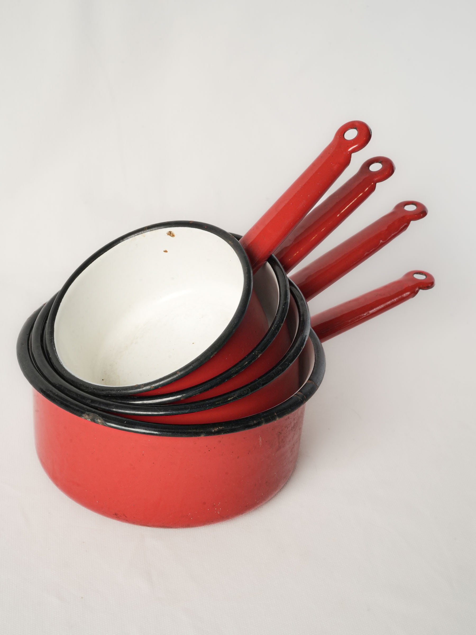 Set of Four Graduated Red Enamel Saucepans