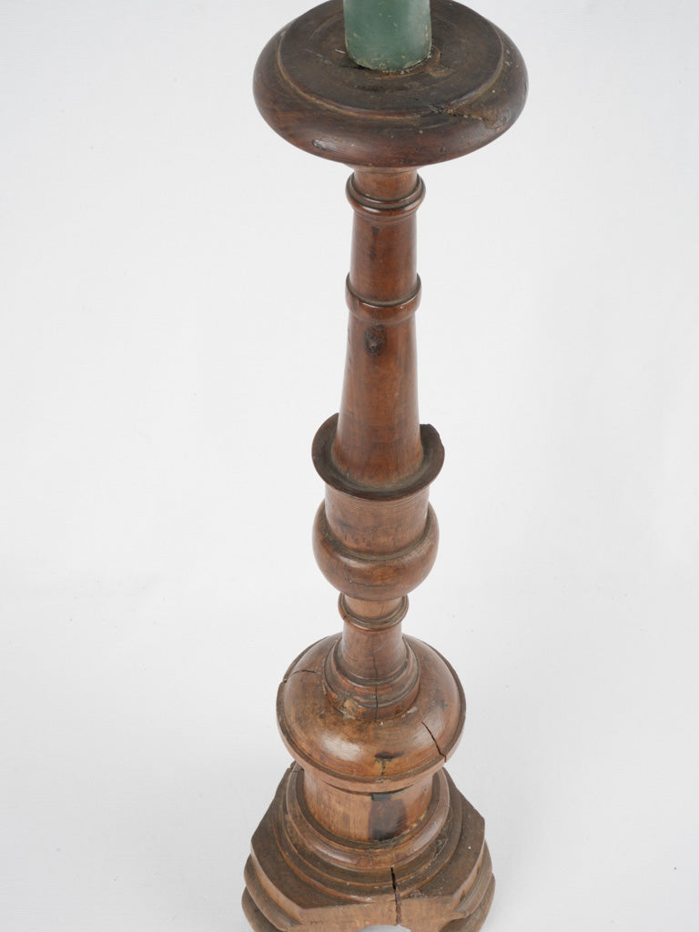 Aged walnut candlestick with intricate base