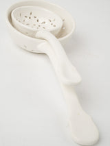 Elegant, traditional white slotted spoons