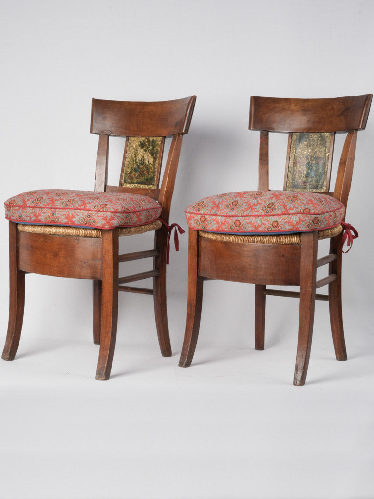 Antique walnut-framed armchairs with paintings