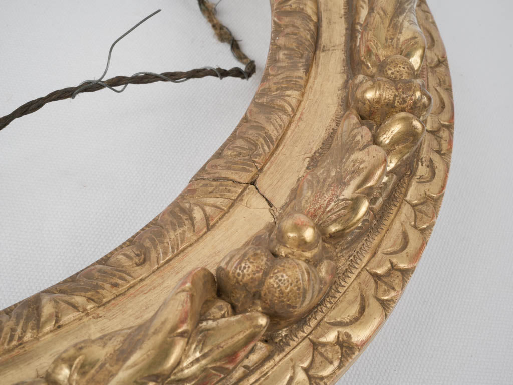 Aged ornamental oval mirror frame