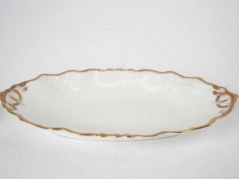 Late 19th century Limoges porcelain dinner service w/ gold border