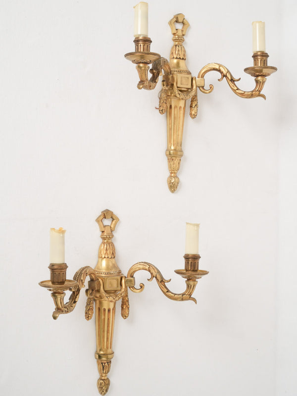 Pair of two-light Louis XVI-style gilded wall sconces