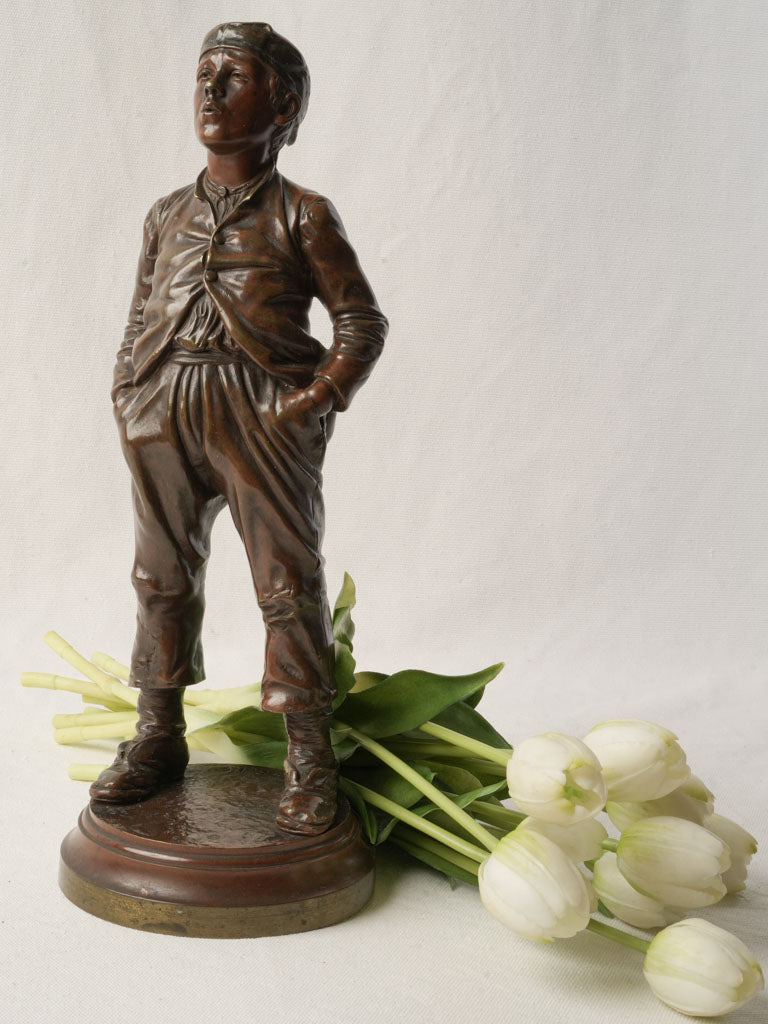 Expressive bronze statuette whistling boy