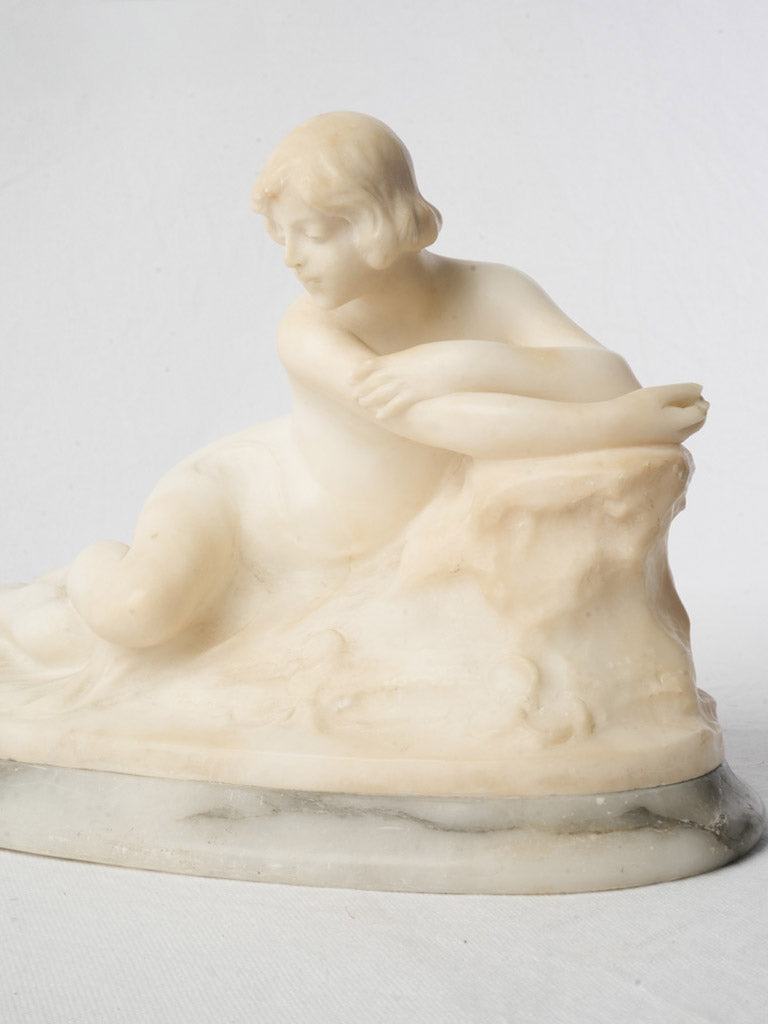 Luminous ivory-toned reclining figure  