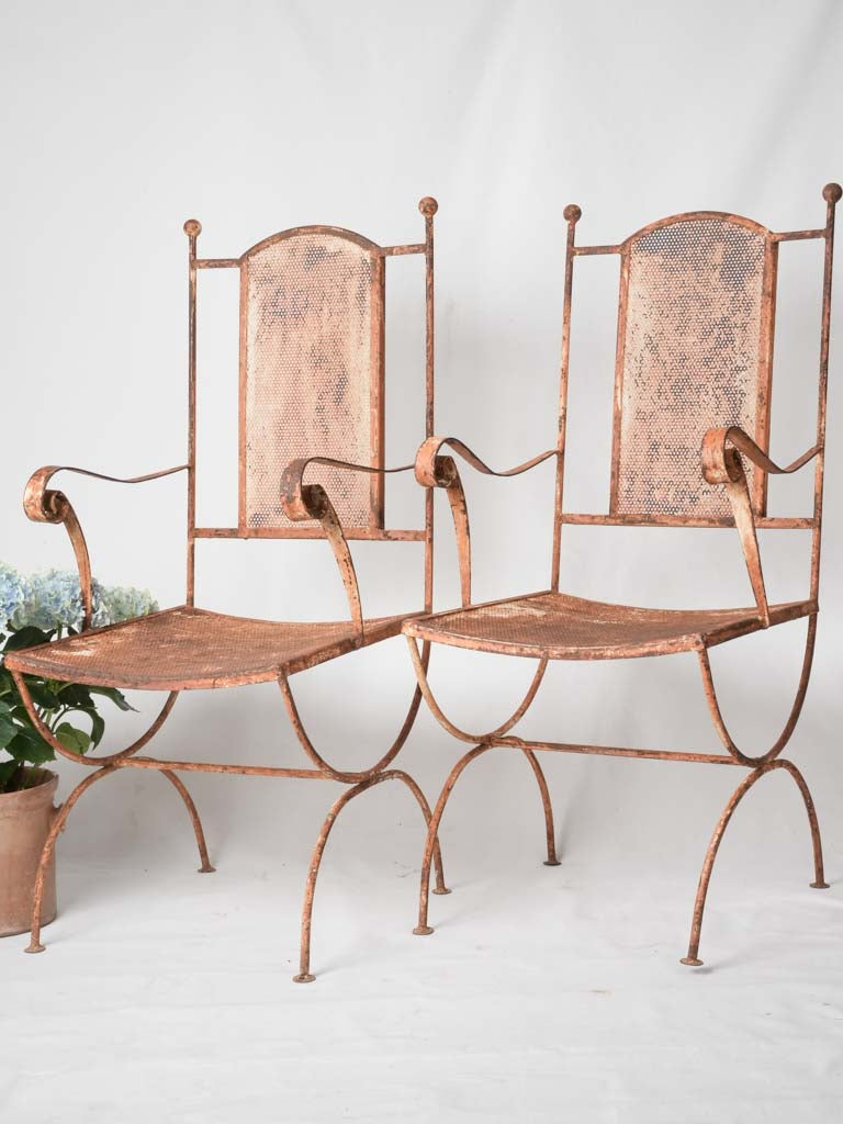 Pair of wrought iron garden armchairs