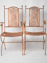 Pair of wrought iron garden armchairs