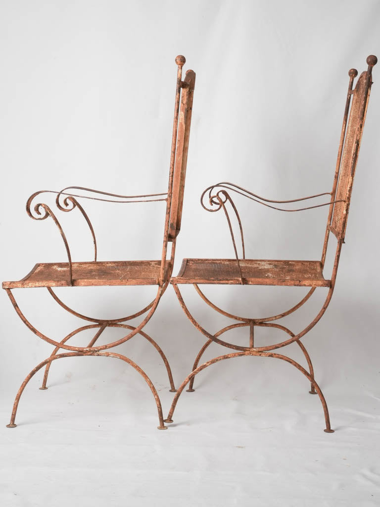 Pair of wrought iron garden armchairs