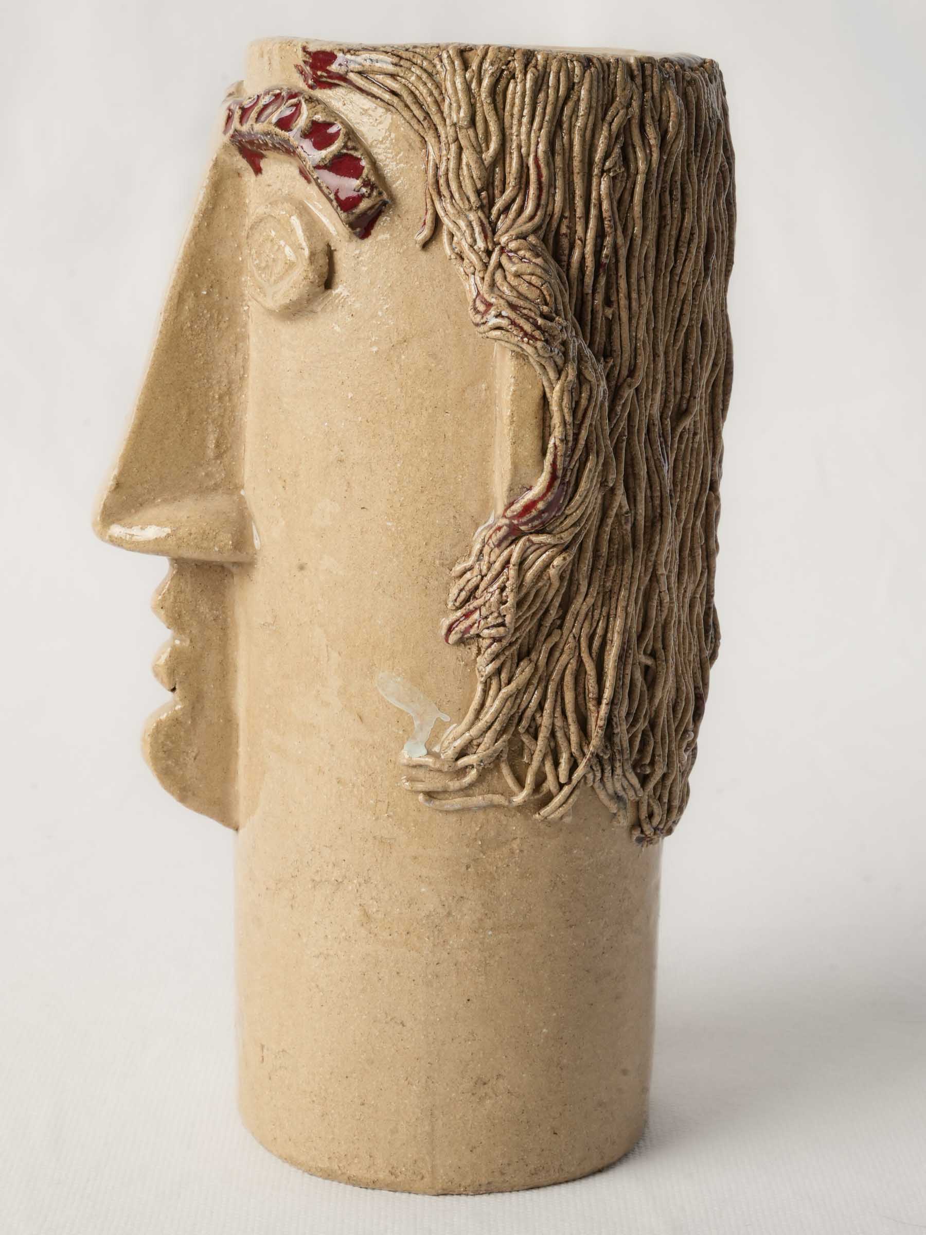 Earthen buff-colored ceramic vessel  