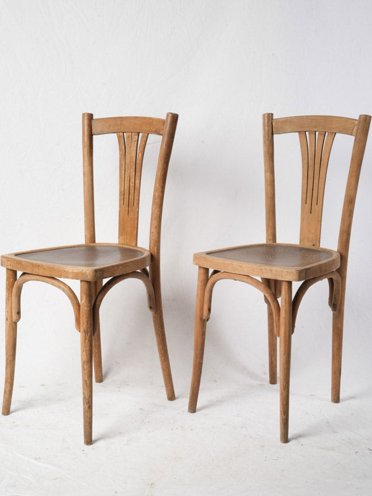 Pair of Early 20th Century French Bistro Chairs w/ Pressed Art Nouveau Seats