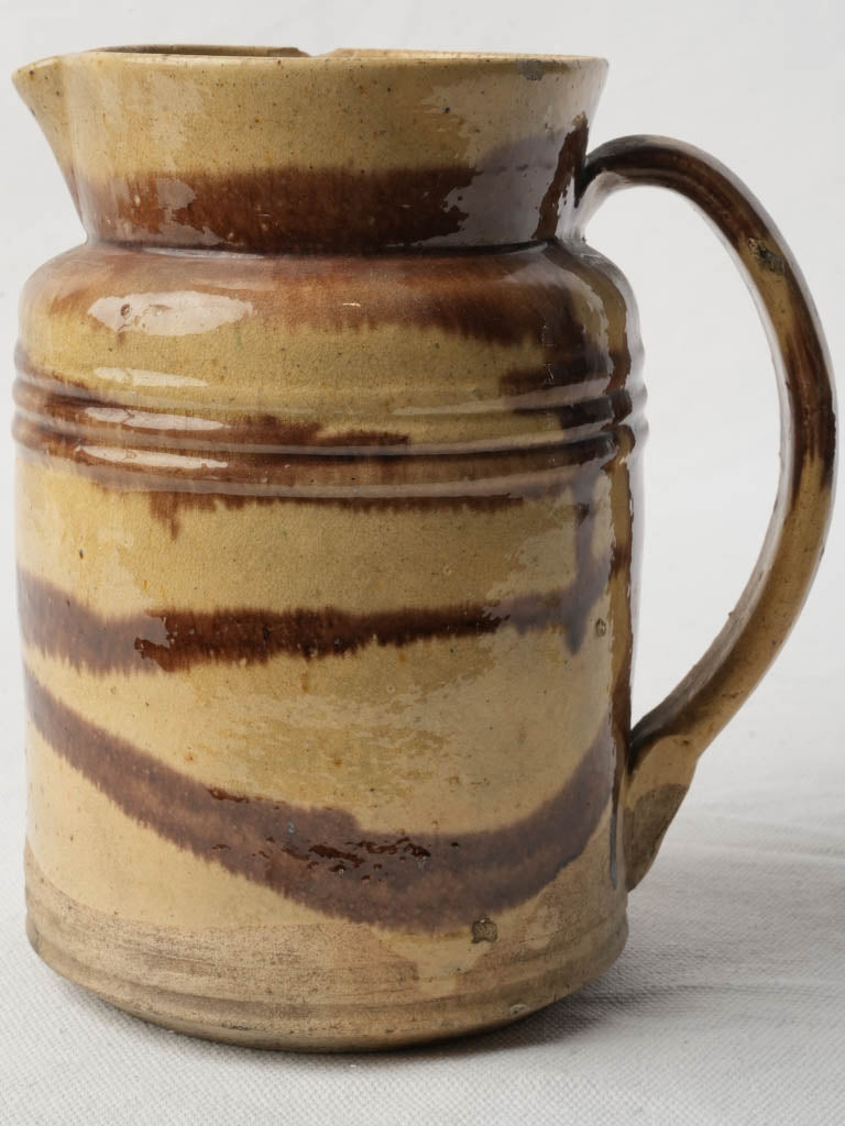 Warm straw-glazed ceramic pitcher
