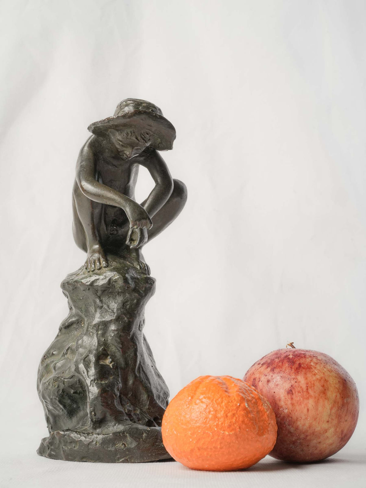 Charming Petite Black-Patinated Bronze Figure of a Crouching Boy on a Rocky Outcrop - 9½"