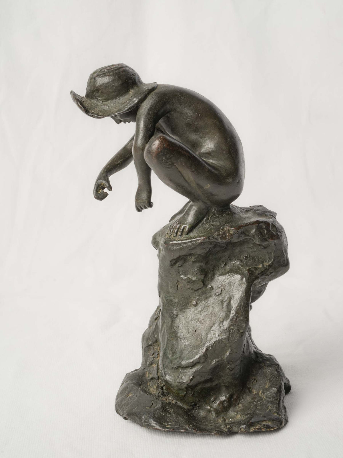Charming Petite Black-Patinated Bronze Figure of a Crouching Boy on a Rocky Outcrop - 9½"