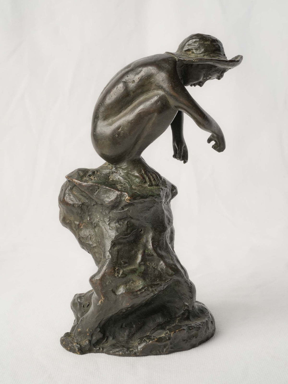 Charming Petite Black-Patinated Bronze Figure of a Crouching Boy on a Rocky Outcrop - 9½"