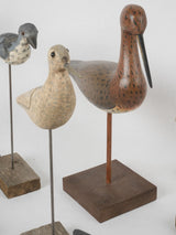 Weathered carved wooden duck statuettes