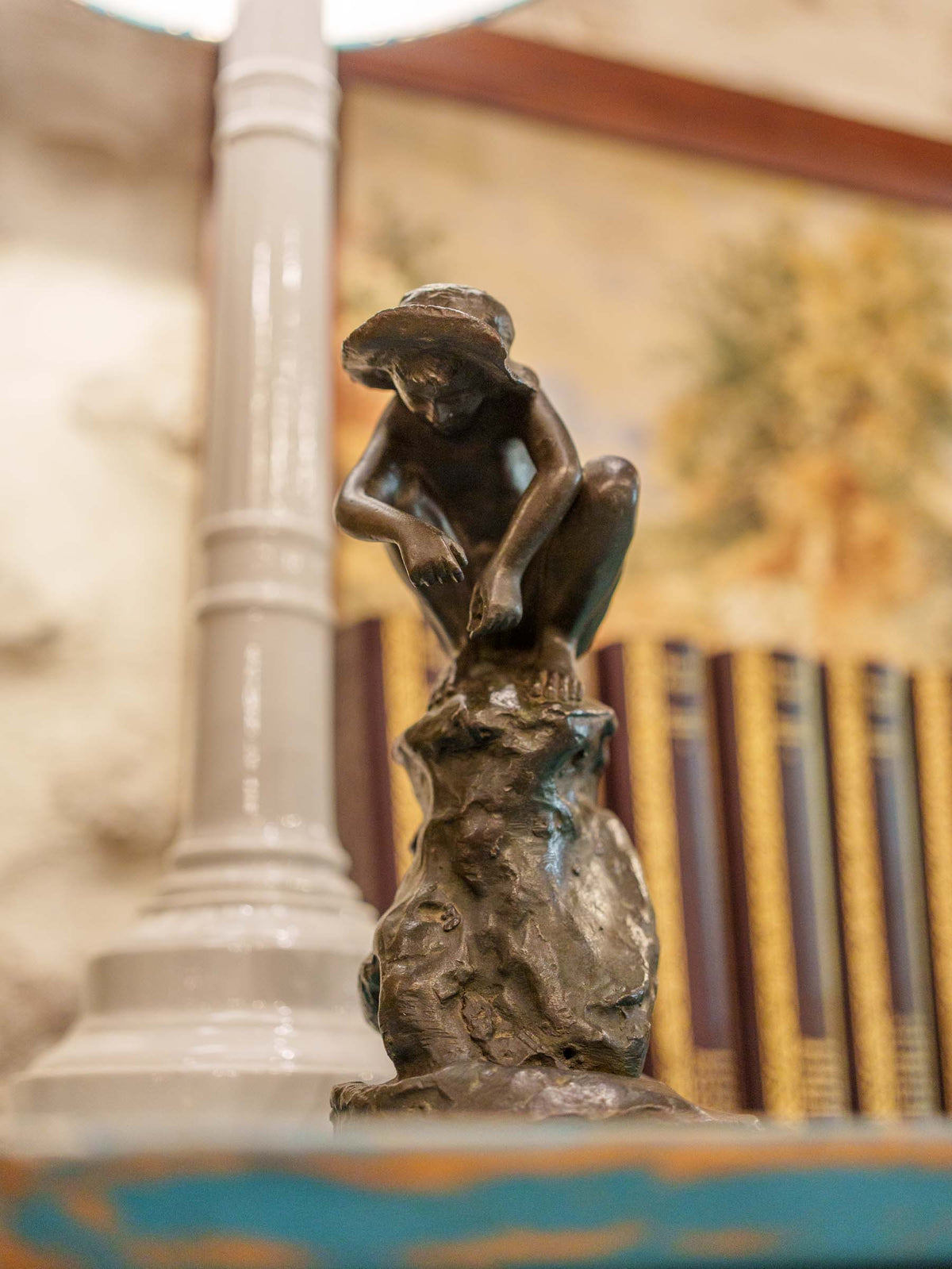 Charming Petite Black-Patinated Bronze Figure of a Crouching Boy on a Rocky Outcrop - 9½"