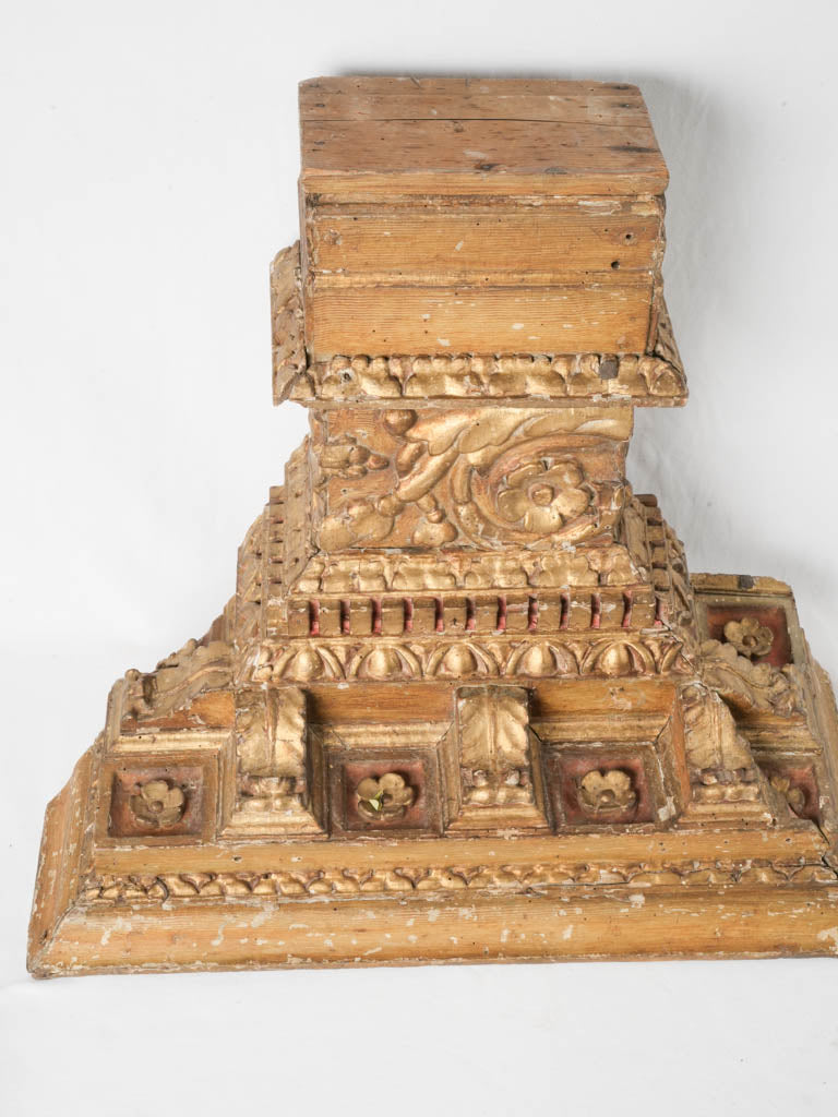 Aged gilded floral wooden capitals
