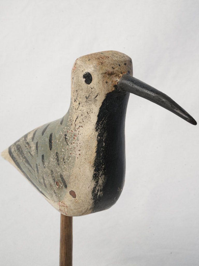 Aged artisanal wooden bird carving  
