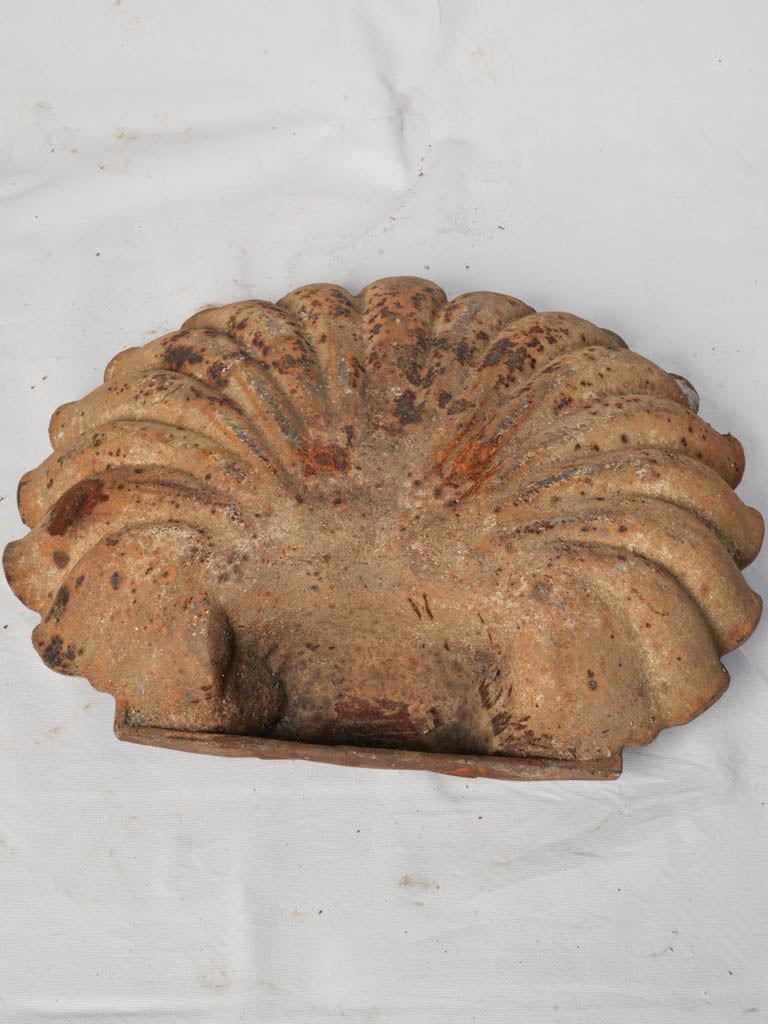 Intricate shell-motif bird bath  
