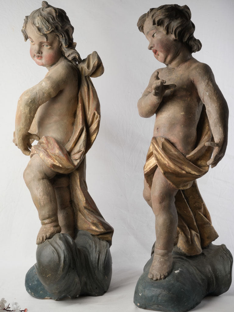 Gilt polychrome wood cherub sculptures  