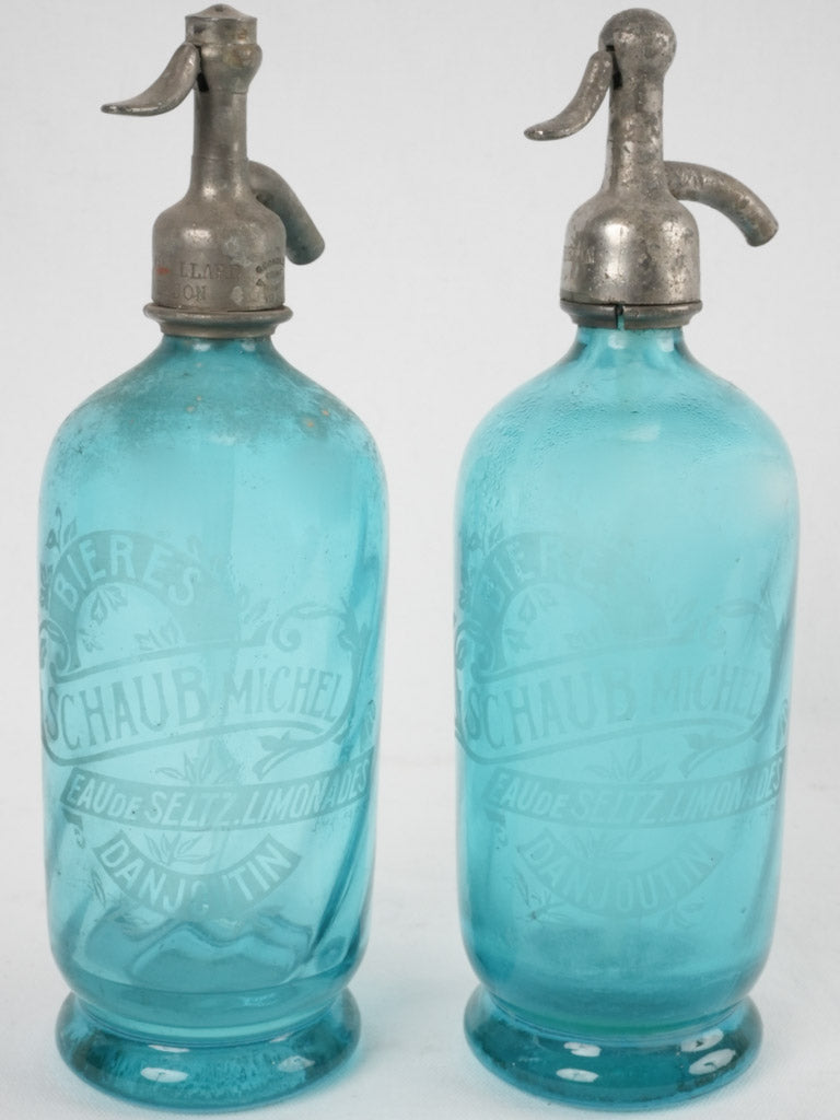 Two blue lemonade seltzer bottles - CHAUB Michel