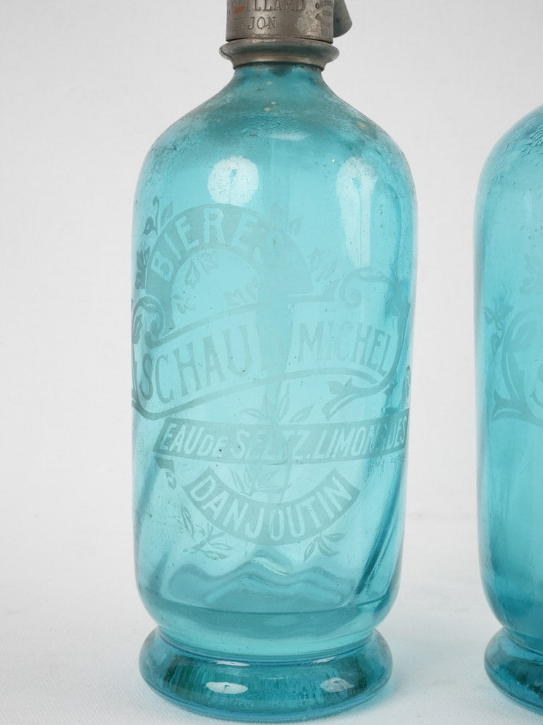 Two blue lemonade seltzer bottles - CHAUB Michel