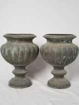 Ornate oxidized bronze garden urns