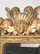Richly decorated, gilded wood framed mirror
