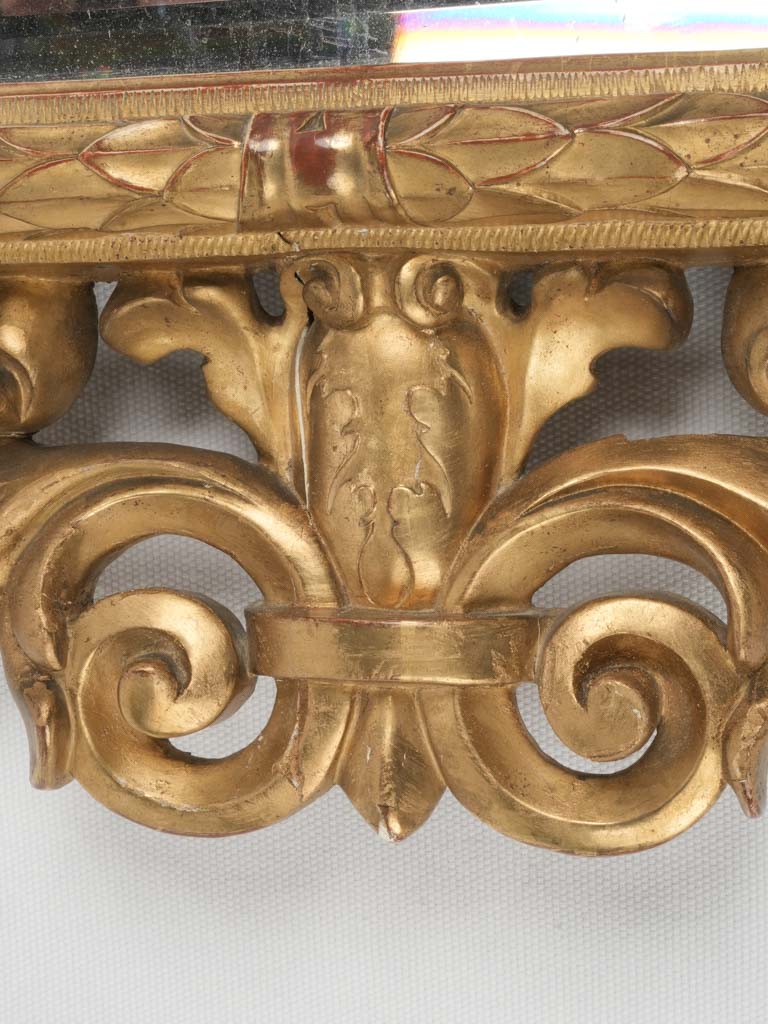 Acanthus leaf-adorned antique gilded mirror