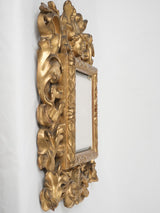 Petite, antique cherub-adorned gilded mirror