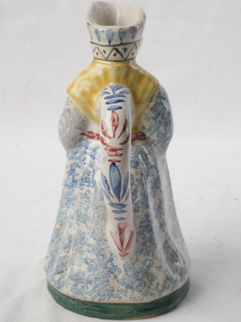 Whimsical blue-accented character pitcher