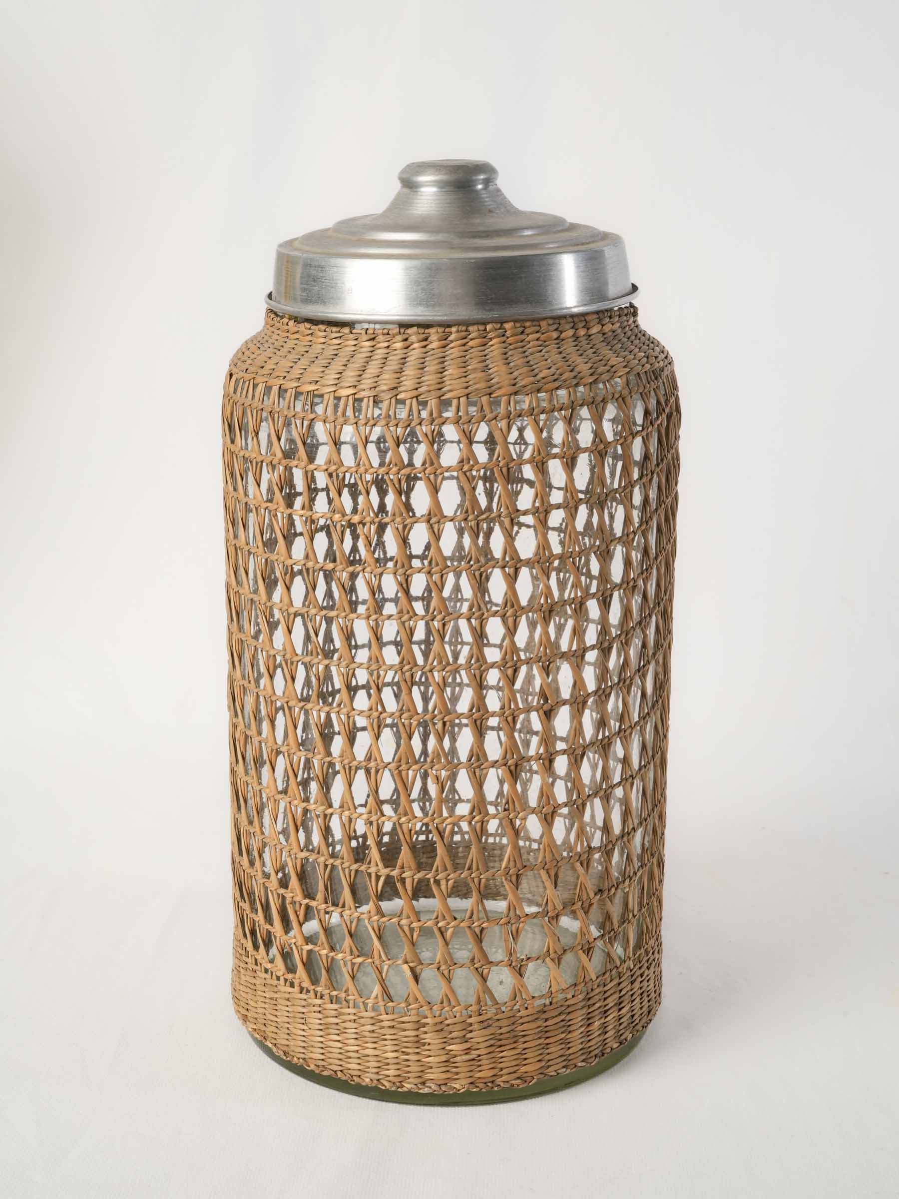 1960s rattan clad glass canister with aluminum lid - 15¾"