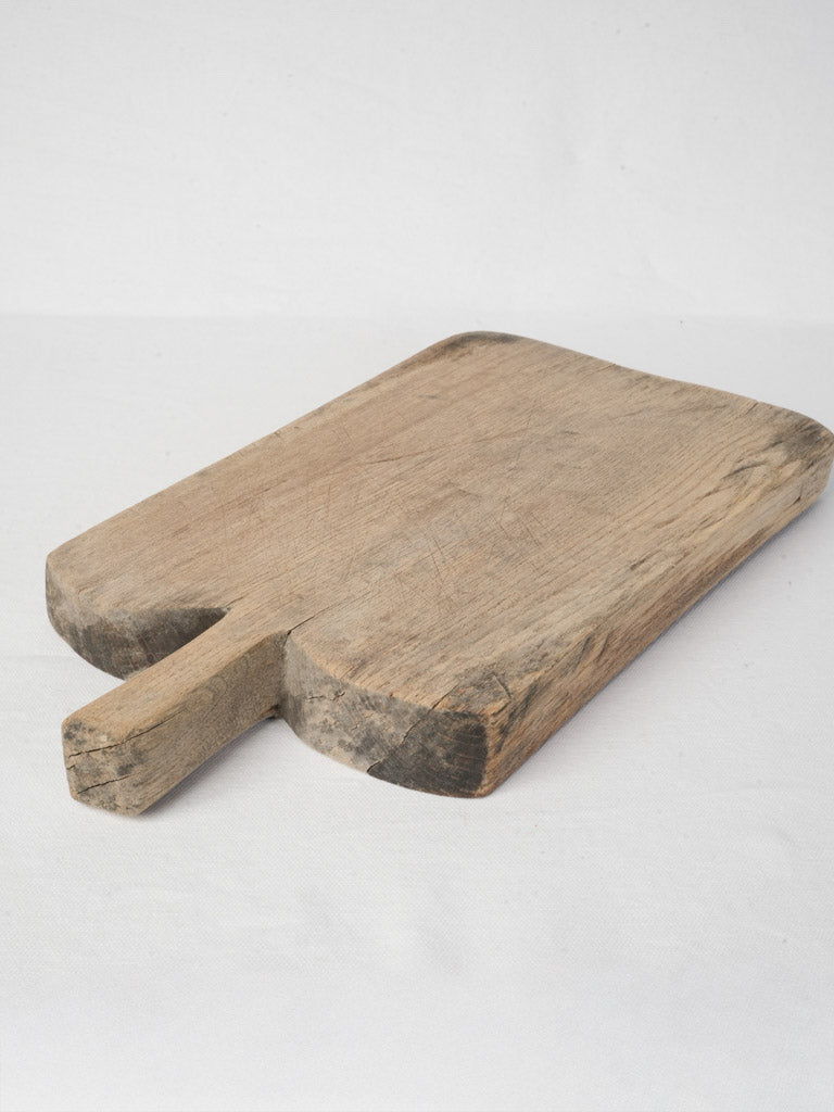Stained rustic bread and cheese board  