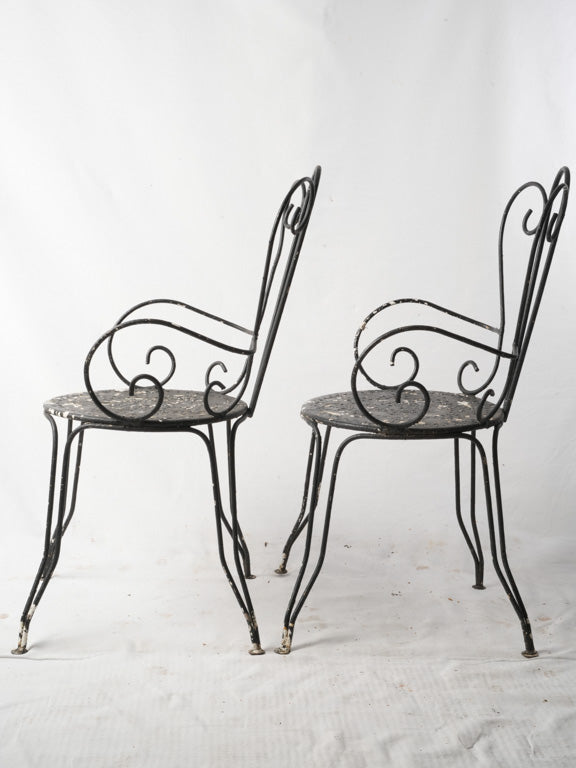 Elegant scrolled iron armchairs  